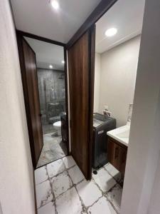 ein Bad mit einer Dusche, einem WC und einem Spiegel in der Unterkunft R3 - Lujoso Loft en la Candelaria in Bogotá