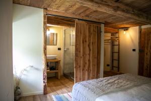 a bedroom with a bed and a glass shower at bnb Uja in Balme