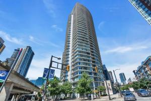 a tall building in the middle of a city at Spacious DT 2-BDR High-rise with view, pool, gym in Vancouver