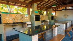 a kitchen with a large counter in a restaurant at Porto Paúba in Pauba