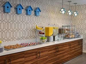 a kitchen with a buffet with fruit and a drink at Sonesta ES Suites Cleveland Westlake in Westlake