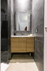 a bathroom with a sink and a mirror at Villa Maiffret YourHostHelper in Cannes