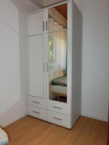 a white cabinet with a mirror in a room at Einliegerwohnung in Stromberg-Schindeldorf in Stromberg