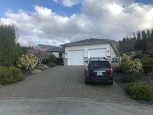 a car parked in the driveway of a house at Licensed spacious basement suite with two king size beds in Chilliwack