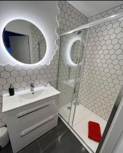 a bathroom with a shower and a sink and a mirror at Llanberis Lodges in Llanberis
