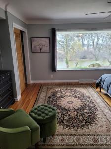 a bedroom with a bed and a large window at dock, game room, bar and private river view patio in Toledo
