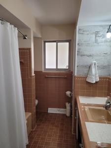 a bathroom with a sink and a toilet and a window at dock, game room, bar and private river view patio in Toledo +28 photos