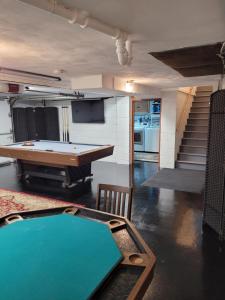 a room with a pool table and a ping pong table at dock, game room, bar and private river view patio in Toledo
