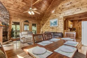 a dining room with a table and chairs in a cabin at Awesome Honey Bear- Get 951 worth of FREE area attraction tickets for each paid day!!! in Sevierville