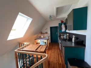 a kitchen with a wooden table in a room at Auszeit im Seenland in Hohenbocka