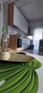 a kitchen with a table with a green leaf on it at Teslić Apartman NiA in Teslić