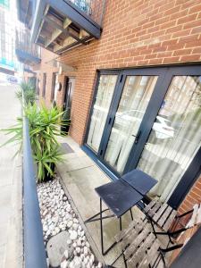 a black chair sitting in front of a building at The ascension 'Ascalon ' in London