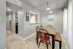 a dining room with a table and chairs at Aloha Condo in Padre Island