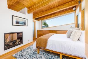 a bedroom with a bed and a fireplace at Downtown Oceanview Luxury Home in Anchorage