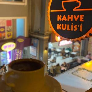 a cup of coffee sitting on top of a table at KULİS HOME OTTOMAN FAMİLY APARTMENTS in Istanbul