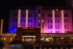 a building with pink and purple lights on it at Hotel Doro City in Tirana