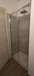 a shower stall with a glass door in a room at Agriturismo Ca' du Nibile di Bove Gabriele in Carbuta