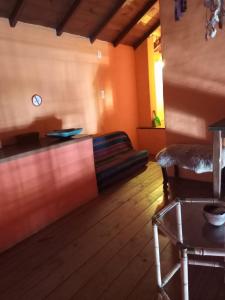 a room with a bed and a table and a chair at Alquileres Viviana in Tandil