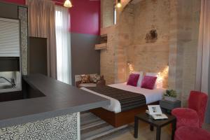 Habitación de hotel con cama y escritorio en Hotel Reine Mathilde, en Bayeux