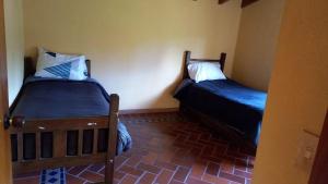 a room with two beds in a room at CASA CAMPESTRE Cucunuba in Cucunubá