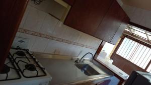 a kitchen with a stove and a sink at CASA CAMPESTRE Cucunuba in Cucunubá