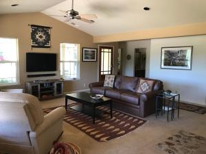 a living room with a couch and a tv at Red Tail Ranch in Groveland