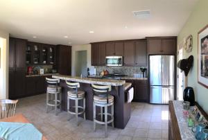 a kitchen with a large island with bar stools at Red Tail Ranch in Groveland