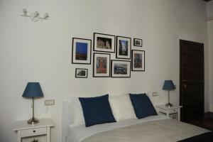 a bedroom with a bed with pictures on the wall at Condotta3Rooms in Florence