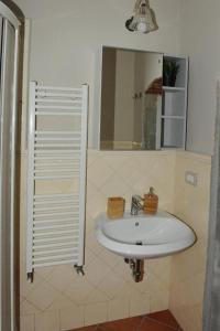 a bathroom with a white sink and a mirror at Condotta3Rooms in Florence