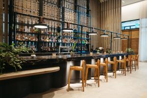 a bar with a row of chairs and bottles at 1 Hotel Nashville in Nashville