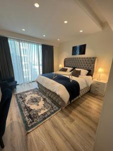 a bedroom with a large bed and a large window at Luxury Apartment in DAMAC Towers in Amman +42 photos