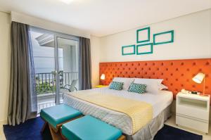 Cama ou camas em um quarto em Doral Guarujá