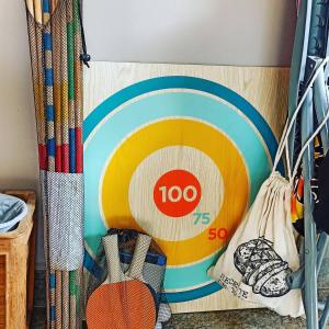 a wall with a plate and tennis rackets at Tiki House in Bora Bora