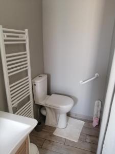 a white bathroom with a toilet and a sink at Naphéo in Tonnay-Charente