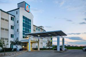 a hotel with a sign on the side of a building at Motel 6-Grande Prairie, AB in Grande Prairie