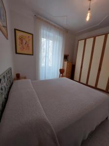a bedroom with a large bed and a window at C r a zy for RHome in Rome