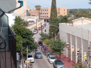 a busy city street with cars parked on the street at depto a 50 m del casino y plaza principal "se aceptan mascotas" in Termas de Río Hondo