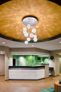 a living room with a ceiling with a chandelier at Sonesta Select Seattle Renton Suites in Renton