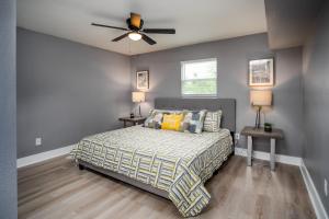 a bedroom with a bed and a ceiling fan at Spacious Home Near Downtown San Antonio in San Antonio