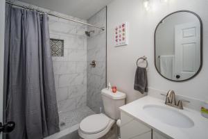Un baño con inodoro, lavabo y espejo. en Spacious Home Near Downtown San Antonio, en San Antonio 8 fotos más
