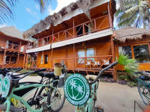 a resort with bikes parked in front of a building at Palmeras de Mahahual Cabañas in Mahahual
