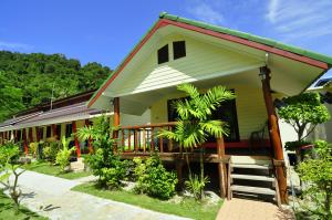 a small yellow house with a red roof at Chongkhao Resort- Phi Phi Island in Phi Phi Don