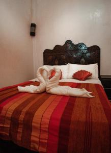 a swan is laying on a bed at Riad chaoui house in Marrakech