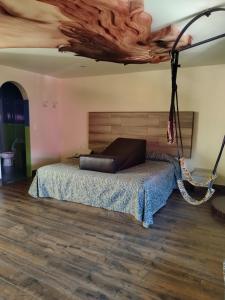 a bedroom with a bed and a wooden floor at Hotel & Villas 7 in Mexico City
