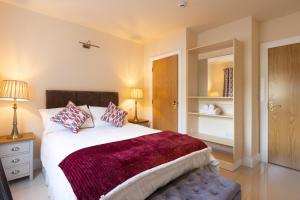 a bedroom with a large bed with two pillows at The Merry Monk Bed and Breakfast in Ballina