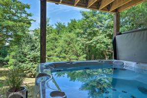 a hot tub with a view of the trees at Pet-Friendly Home in Heart of Wine Country! in Linden
