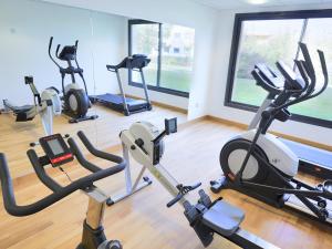 a gym with several treadmills and exercise bikes at Kyriad Angers Ouest Beaucouzé in Beaucouzé