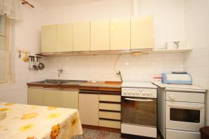 a kitchen with white appliances and a table in it at Rooms by the sea Sucuraj, Hvar - 6734 in Sućuraj