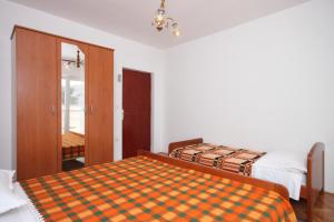 a bedroom with two beds and a door to a balcony at Triple Room Metajna 6378d in Metajna