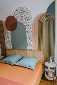 a bedroom with a bed with a headboard and a table at Passage de l'Horloge in Auxerre